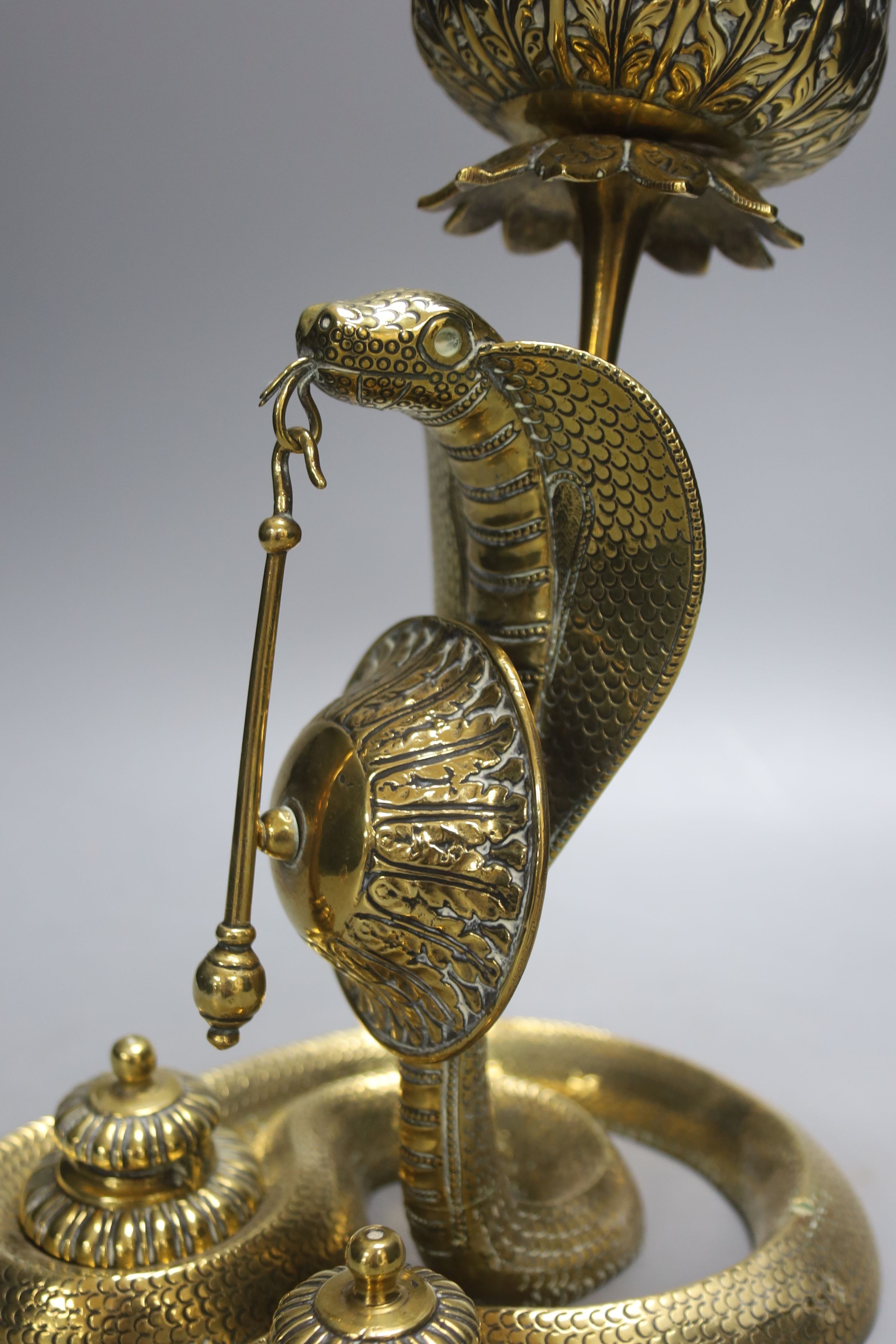 An Indian brass ‘cobra’ desk stand, 26 cms high.